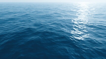 Fototapeta premium calm blue sea surface with sun reflection, soft ripples, peaceful water