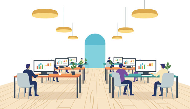Employees working at desks in open office space with multiple computer monitors and warm hanging pendant lights illuminating the workspace.