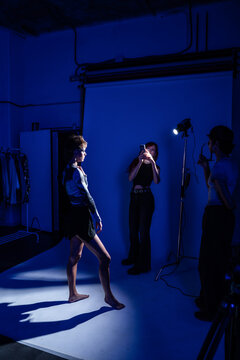 Fashion photo shoot in studio with model and crew