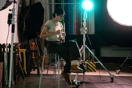 Photographer taking a break on set in studio lighting