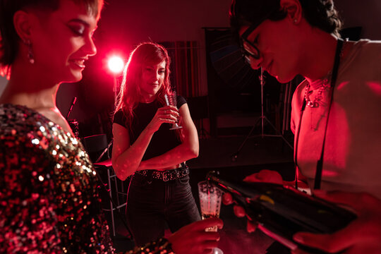 Fashion photoshoot crew celebrate backstage with drinks
