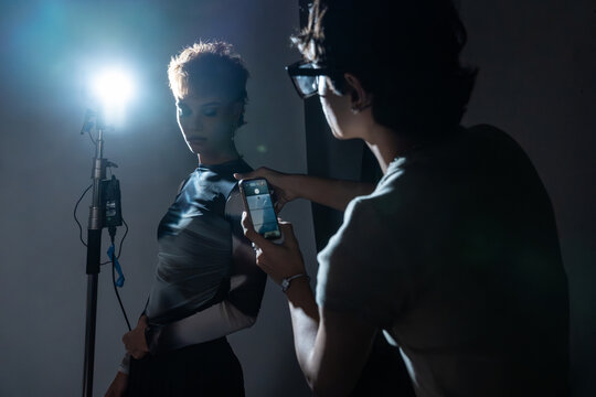 Behind the scenes fashion shoot with photographer and model