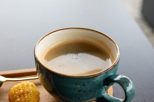 Black coffee with madeleine biscuit