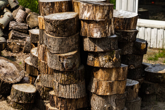 Stacked round firewood logs outdoors