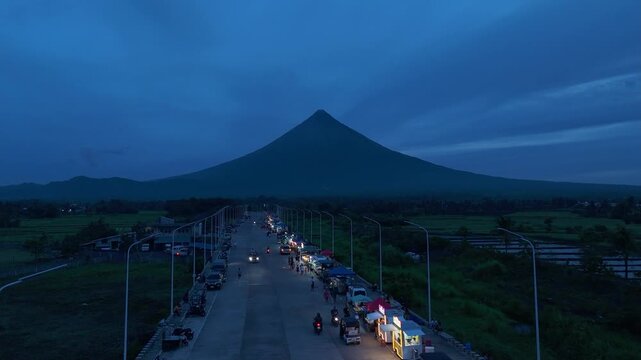 Aerial view of the new road capturing Mount Mayon at dusk, Tabaco City,Philippines. Ideal for travel and urban concepts.