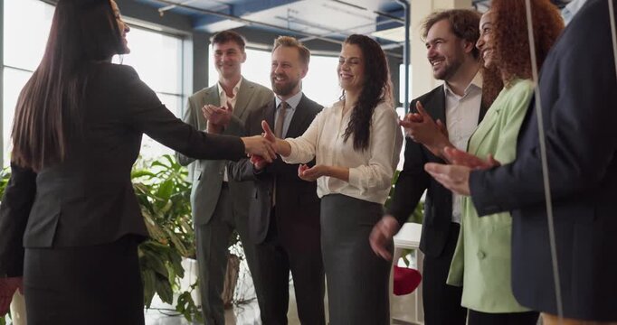 Business people handshake team meeting success agreement. Colleagues applaud in a modern office as partners confirm a contract. Useful for hiring visuals. Clear teamwork and agreement concept.