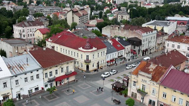 High angle stationary shot from the city hall tower overlooking historic colorful buildings and the pedestrian Rynok Square plaza in the old town of Drohobych, Ukraine.