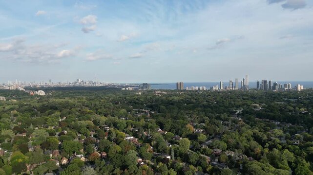 Aerial over the Kingsway in Toronto, Ontario, Canada. Bloor Street West. Moving left looking forward southeast towards the downtown core Toronto skyline, Humber River, Mimico and Lake Ontario.