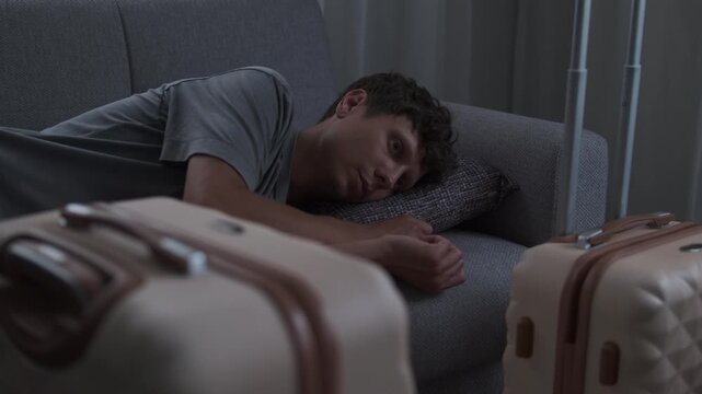 Close up of man struggling to adapt after moving, feeling disconnected and out of place in temporary living situation