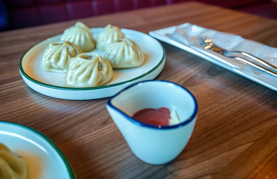 These dishes are called buuz (or pozy) and are a traditional dish of Buryat and Mongolian cuisine. They are steamed and filled with a juicy mixture of ground beef and pork seasoned with onions.