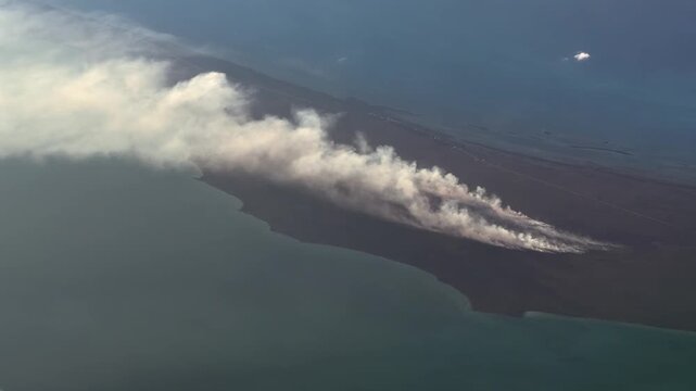 a large bush fire on Little Abaco Island (June 2026), The Bahamas near Cedar Harbor with a large cloud of smoke is drifting westward - 4k aerial video footage