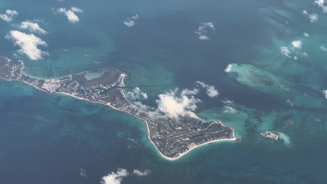 flying across The Bahamas, with Great Guana Cay as part of Abaco Island, surrounded by shallow turquoise water surface, with Golf resorts and yacht harbor, located in the Caribbean Sea -4k footage