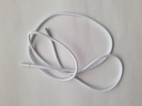 A single white drawstring cord with plastic aglets isolated on white background