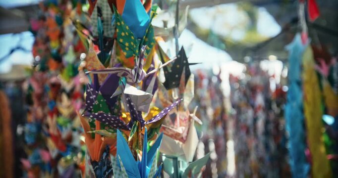 Colorful Origami Paper Cranes Hanging on String in Hiroshima - closeup slow motion shot