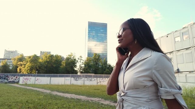 Business woman using phone in the city. Warsaw, Poland
