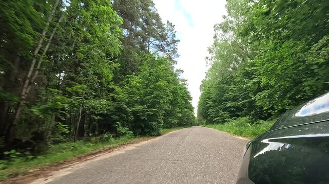 AAerial north Poland forest road POV. Rural country dirt road forest and farms Poland POV. Farm manor house, stone homes, old villages in rural country farming landscape forest and agriculture.