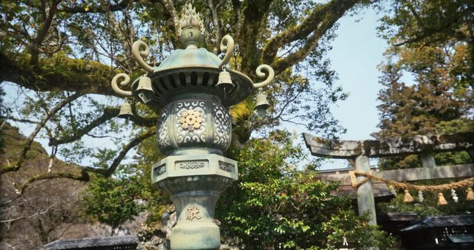 Bronze Lantern with Bells at Japanese Shrine Hiroshima, steady cam movement
