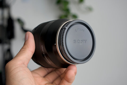 Zapopan Jalisco, Mexico - June 13, 2026: Hand holding Tamron 24mm F2.8 Di III OSD M12 lens for Sony E-mount, tamron lens concept
