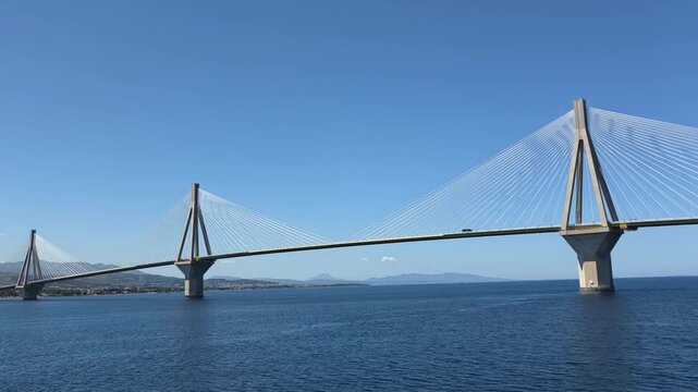 Smooth ferry perspective of the Rio Antirrio Bridge in Greece, showcasing modern engineering, transportation infrastructure and coastal scenery.