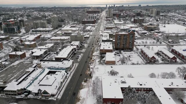 Aerial over Mississauga, Ontario, Canada during a winter morning after snowfall, March, 2023. Moving south over the Cooksville area towards Lake Ontario along Highway 10 Hurontario Street.