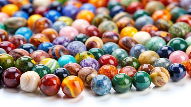 Assortment of multicolored natural stone beads arranged flat on a white surfaceideal for decorative or design use