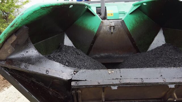 Road construction. Asphalt pavement machine making new layer of asphalt