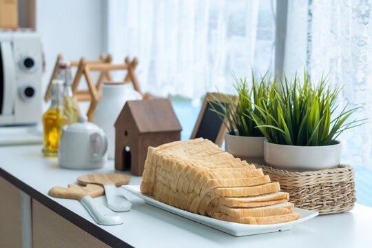 bread and butter on the table. Breakfast to be prepare. Morning breakfast on a table above, waffles with cream, berries, coffee, cappuccino, bowl, omlet with vegetables, bread with butter.