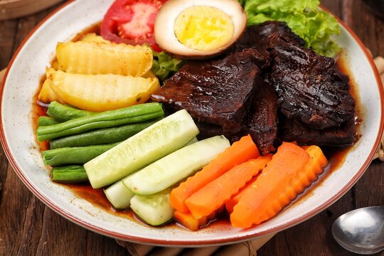 Selat Solo, a classic Javanese beef salad and soup from Surakarta, Central Java, Indonesia. Served with tender beef, boiled vegetables, potatoes, eggs, lettuce, and a sweet savory broth