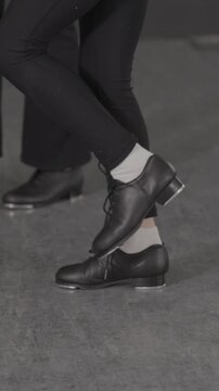 Tap dancer in a modern studio close up on feet