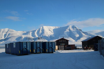 Longyearbyen town panorama in Svalbard, Norway. Remote arctic settlement with colorful houses, traditional wooden architecture, industrial heritage under winter snow and majestic polar mountains. © 國樹潘