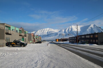 Longyearbyen town panorama in Svalbard, Norway. Remote arctic settlement with colorful houses, traditional wooden architecture, industrial heritage under winter snow and majestic polar mountains. © 國樹潘