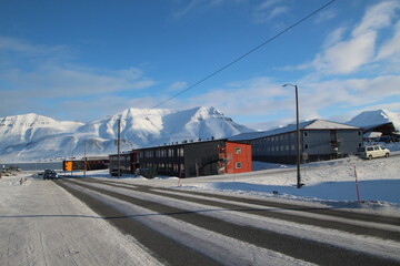 Longyearbyen town panorama in Svalbard, Norway. Remote arctic settlement with colorful houses, traditional wooden architecture, industrial heritage under winter snow and majestic polar mountains. © 國樹潘
