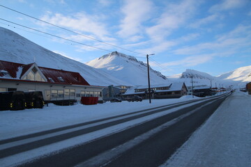 Longyearbyen town panorama in Svalbard, Norway. Remote arctic settlement with colorful houses, traditional wooden architecture, industrial heritage under winter snow and majestic polar mountains. © 國樹潘
