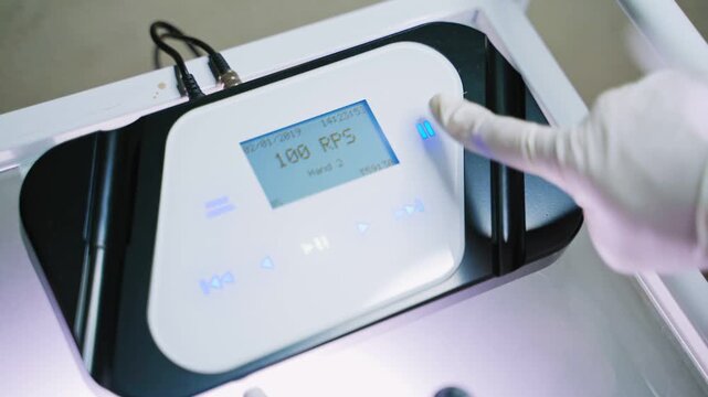 Permanent makeup professional machine setup with digital interface and needle tool close up.