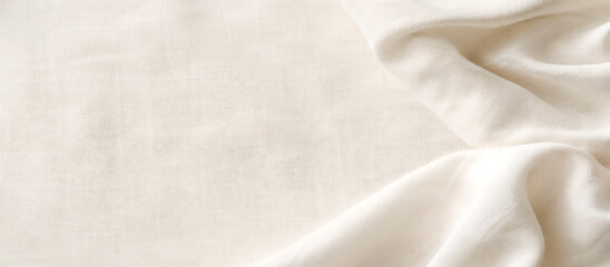 Fototapeta premium White linen fabric background with soft drapery folds and natural textile texture.