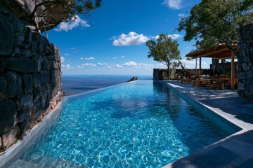Obraz premium Infinity Pool Overlooking the Calm Blue Sea Under Clear Sky