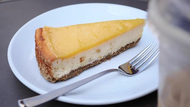 Enjoying cake slice at cafe in sunny afternoon