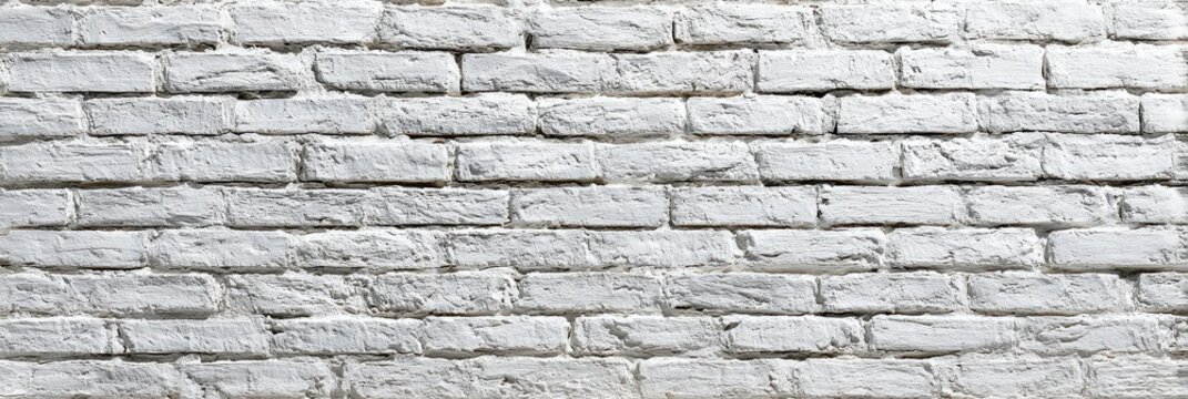 Textured white brick wall, a common background for diverse artistic applications