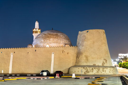 Beautifully illuminated mud brick walls and dome of the historic Ibrahim Palace at night in Al Hofuf, Saudi Arabia.