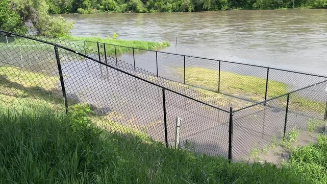 Winnipeg River Flooding After Heavy Rain.Flooded river and submerged park areas in Winnipeg, Manitoba, following intense rainfall. Storm clouds and high water levels highlight urban flood risk and ext