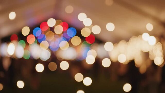 Blurred view of celebratory string lights and Christmas lights, creating a festive party atmosphere