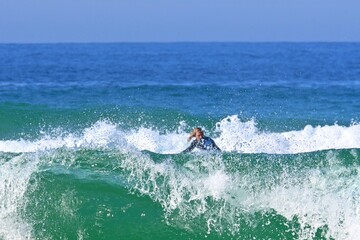 Obraz premium Surfing in the mighty ocean waves off the Atlantic coast of Ferrol, Spain May 12, 2026