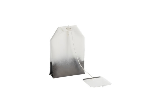 Empty white tea bag with tag on white surface