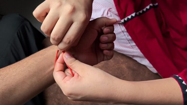 Sister tying rakhi on her brother's wrist on raksha bandhan festival