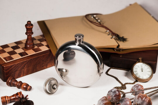 stainless steel silver hip flask with vintage gentleman accessories: wooden box and antique pocket watch