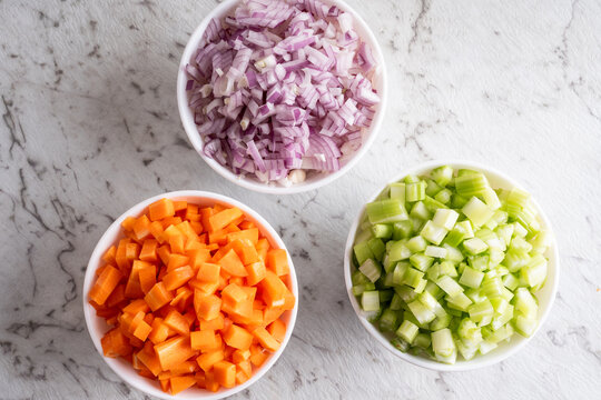 Celery, red onion and carrot diced in bowls