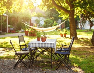 Fototapeta premium Cozy outdoor scene with a table, chairs, hammock, and greenery bathed in sunlight