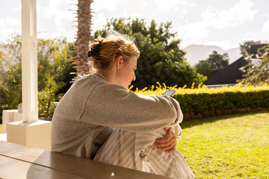 young woman using mobile phone outdoors