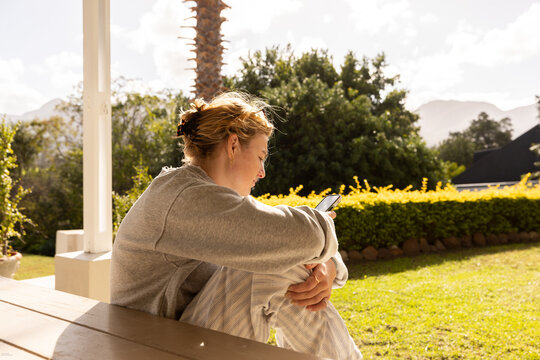 young woman using mobile phone outdoors