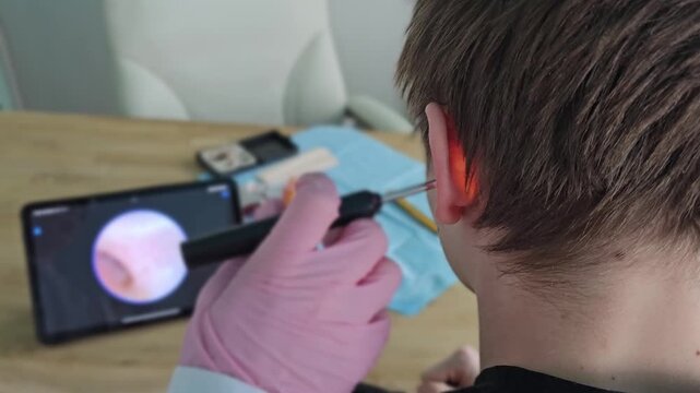 Learning proper techniques for using an otoscope to examine ear infections in a clinic setting